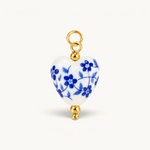 Nadare Co. porcelain heart charm featuring blue floral patterns, 14k gold-plated accents, and a stainless steel ring.