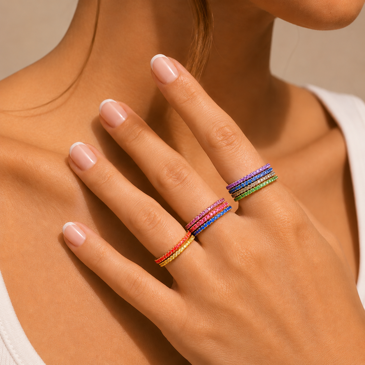 Nadare Co. Prism Birthstone rings in a colorful stack worn on a woman's fingers, featuring vibrant gemstone bands.