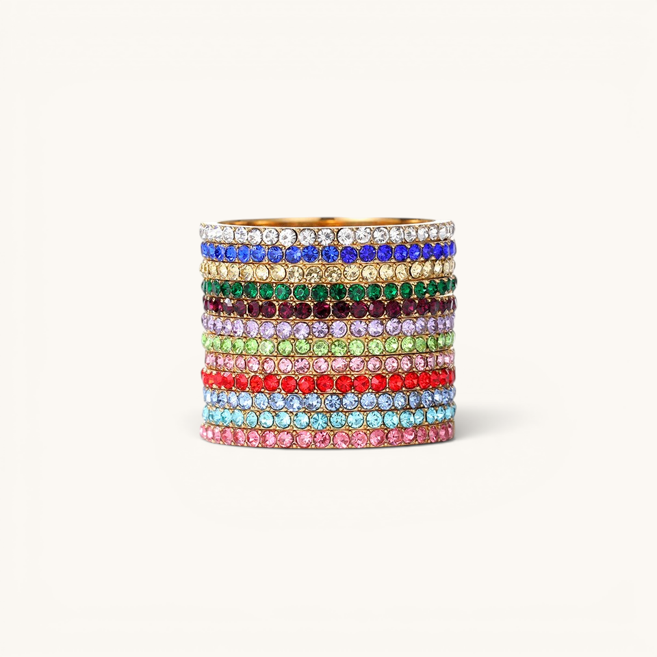 Nadare Co. Prism Birthstone Ring stack featuring multiple vibrant crystal-encrusted bands in various colors.