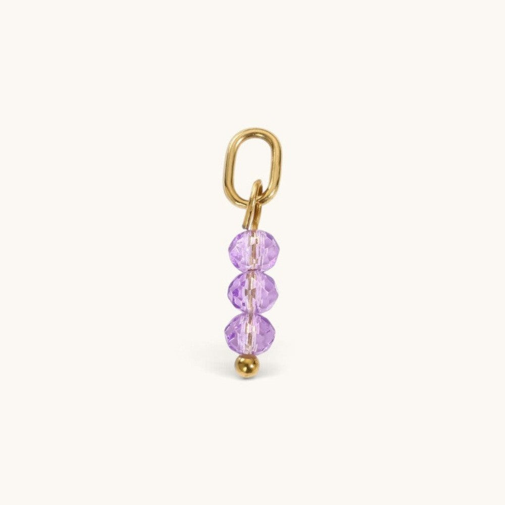 Nadare Co. birth month bead charm with three faceted purple crystals on a gold-tone jump ring for necklace stacking.
