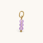 Nadare Co. birth month bead charm with three faceted purple crystals on a gold-tone jump ring for necklace stacking.