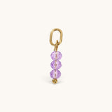Nadare Co. birth month bead charm with three faceted purple crystals on a gold-tone jump ring for necklace stacking.