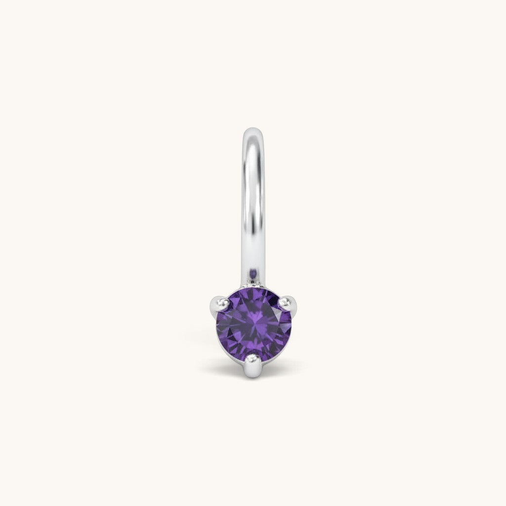 Nadare Co. mini birthstone charm featuring a round purple cubic zirconia stone in a silver-tone setting