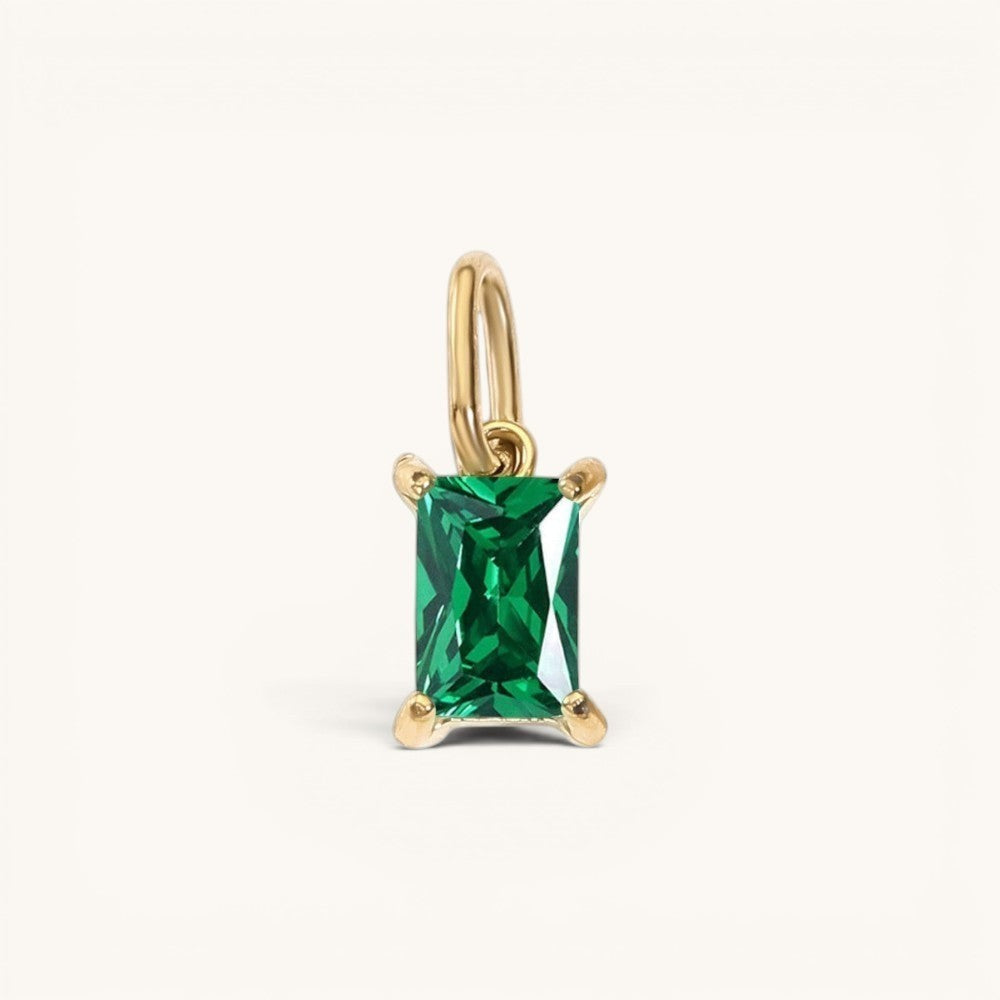 Nadare Co. rectangle birthstone charm featuring a vibrant green emerald-cut gemstone set in polished yellow gold.