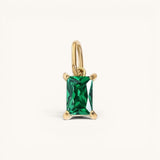 Nadare Co. rectangle birthstone charm featuring a vibrant green emerald-cut gemstone set in polished yellow gold.
