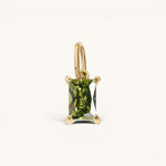 Nadare Co. rectangle birthstone charm featuring a faceted olive green gemstone set in polished yellow gold.