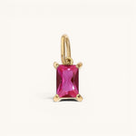 Nadare Co. rectangle birthstone charm featuring a vibrant pink gemstone set in polished gold on a simple bail.