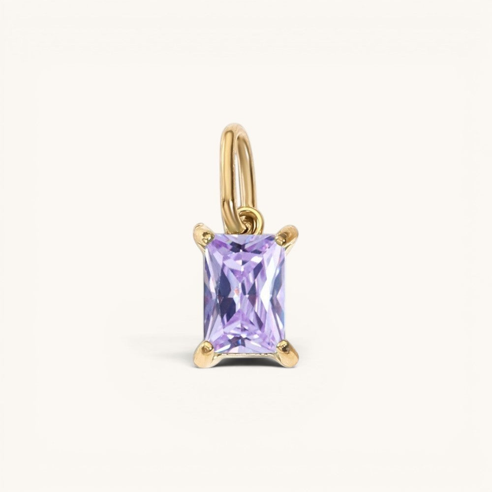 Nadare Co. rectangle birthstone charm featuring a light purple gemstone set in polished gold on a small jump ring.