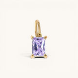Nadare Co. rectangle birthstone charm featuring a light purple gemstone set in polished gold on a small jump ring.