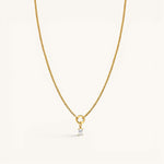 Nadare Co. gold chain necklace featuring a delicate rectangular birthstone charm on a circular pendant loop.
