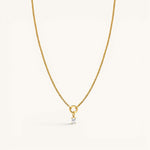 Nadare Co. gold chain necklace featuring a delicate rectangular birthstone charm on a circular pendant loop.