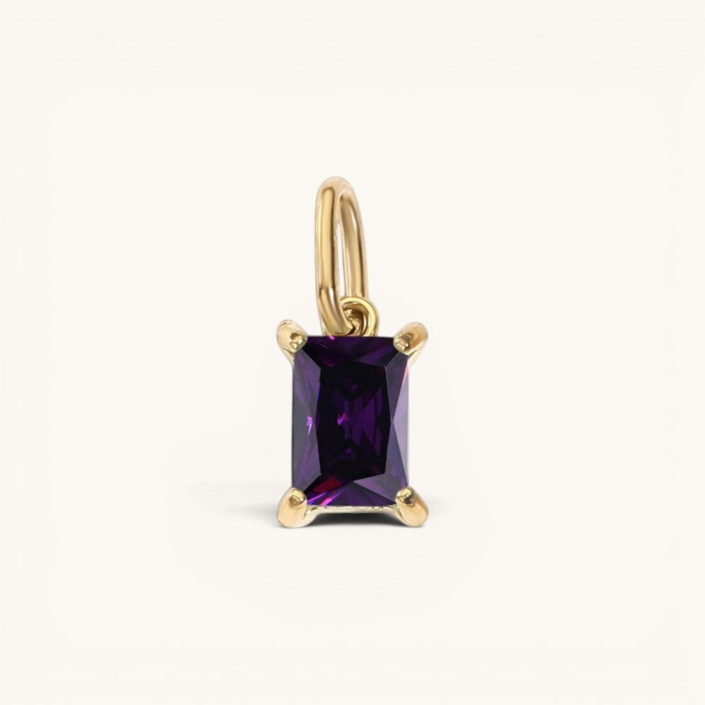 Nadare Co. rectangle birthstone charm featuring a deep purple rectangular gemstone set in polished gold.