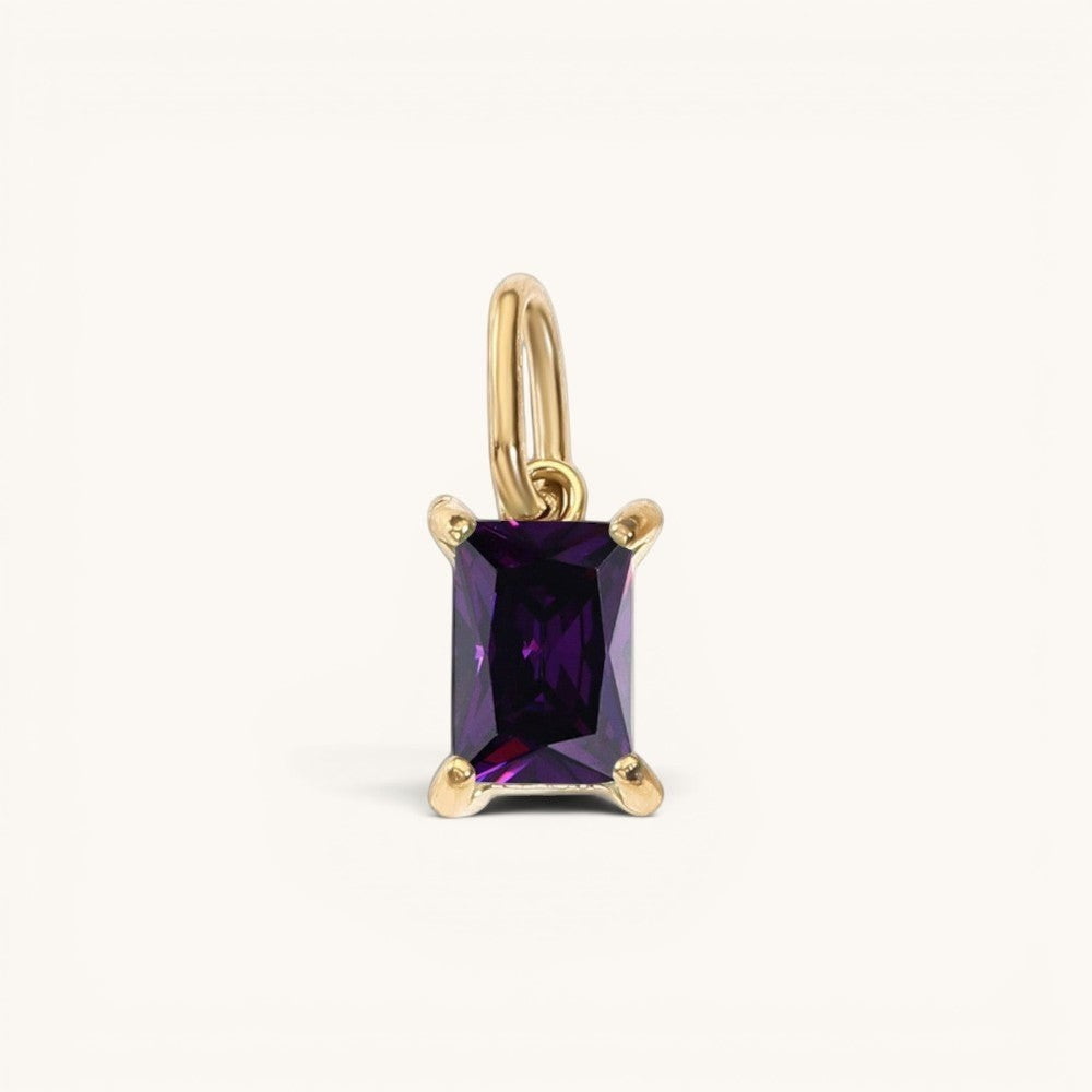 Nadare Co. rectangle birthstone charm featuring a deep purple rectangular gemstone set in polished gold.
