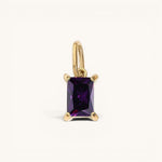 Nadare Co. rectangle birthstone charm featuring a deep purple rectangular gemstone set in polished gold.