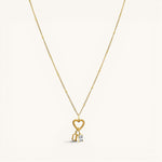 Nadare Co. gold necklace featuring a heart-shaped clasp charm with a dangling rectangle birthstone and letter charm.