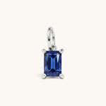Nadare Co. rectangle birthstone charm featuring a deep blue cubic zirconia stone in a polished silver-tone setting.