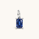 Nadare Co. rectangle birthstone charm featuring a deep blue cubic zirconia stone in a polished silver-tone setting.