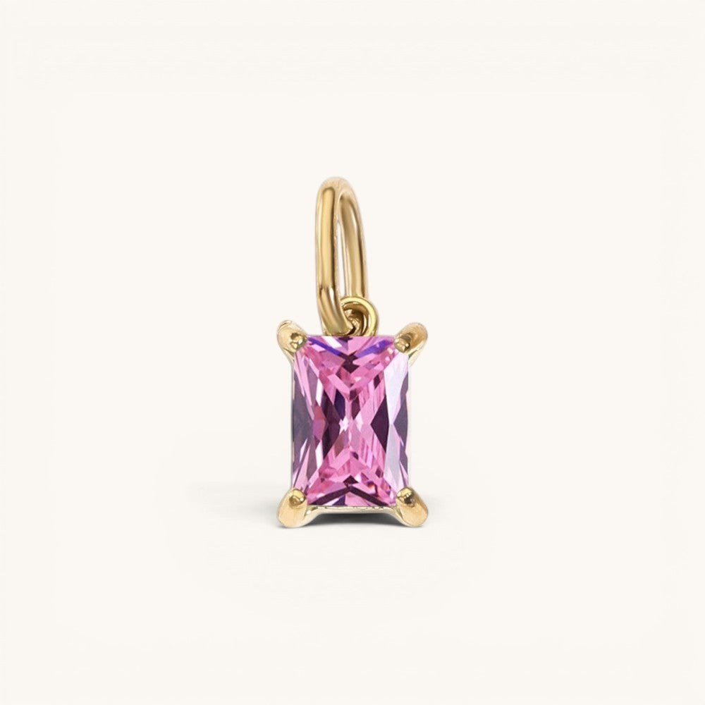 Nadare Co. rectangle birthstone charm featuring a pink faceted gemstone set in gold on a simple jump ring.