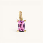 Nadare Co. rectangle birthstone charm featuring a pink faceted gemstone set in gold on a simple jump ring.