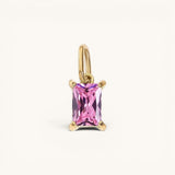 Nadare Co. rectangle birthstone charm featuring a pink faceted gemstone set in gold on a simple jump ring.