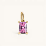 Nadare Co. rectangle birthstone charm featuring a pink faceted gemstone set in gold on a simple jump ring.