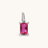 Nadare Co. rectangle birthstone charm featuring a vibrant pink cubic zirconia stone set in polished silver metal.