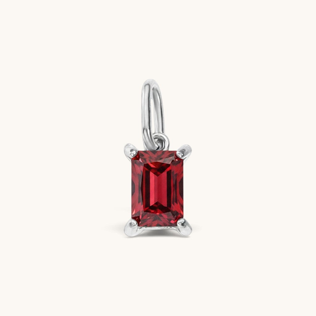 Nadare Co. rectangle birthstone charm featuring a vibrant red cubic zirconia stone set in polished silver-tone metal.