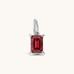 Nadare Co. rectangle birthstone charm featuring a vibrant red cubic zirconia stone set in polished silver-tone metal.