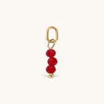 Nadare Co. birth month bead charm featuring three faceted red beads and a gold jump ring for necklace stacking.