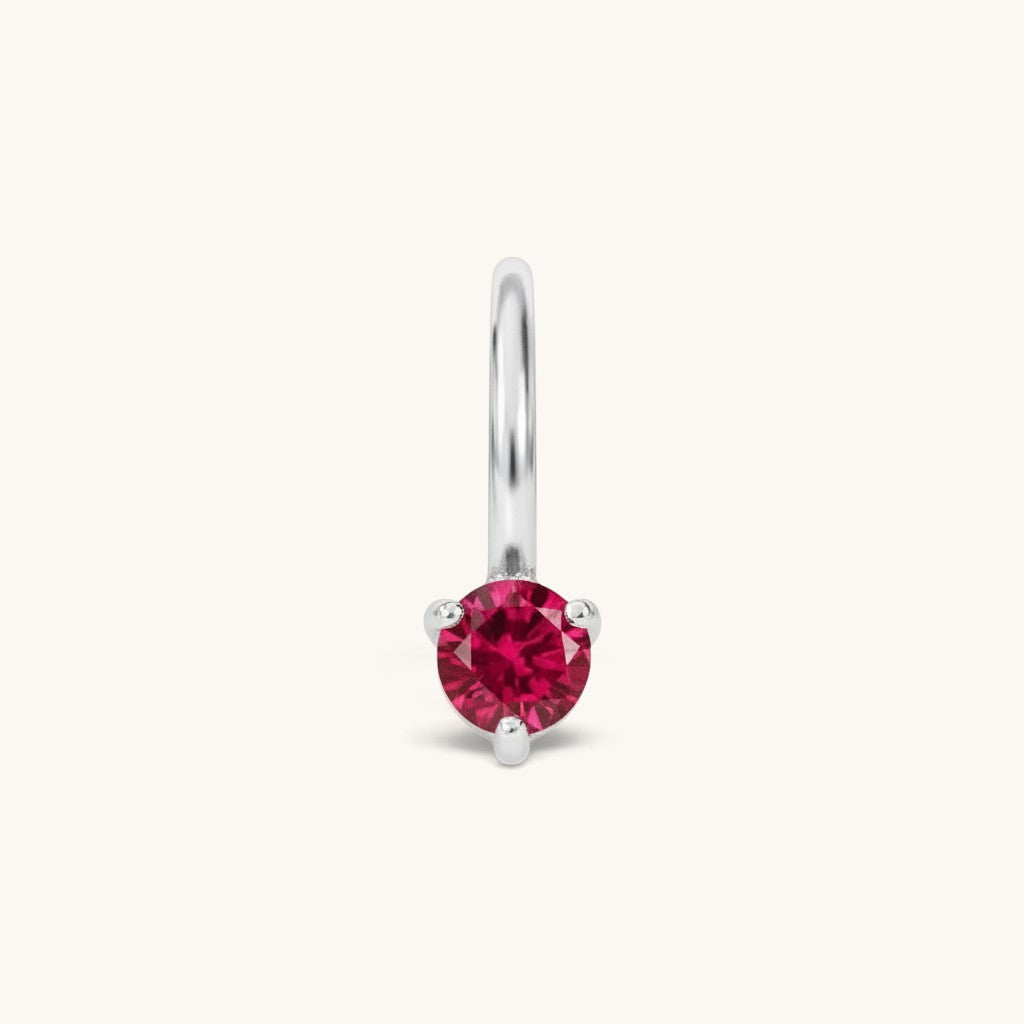 Nadare Co. mini birthstone charm featuring a round red cubic zirconia stone set in silver-toned stainless steel.