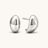 Nadare Co. Remi earrings featuring a chunky, sculptural silver hoop design with a smooth, polished finish.