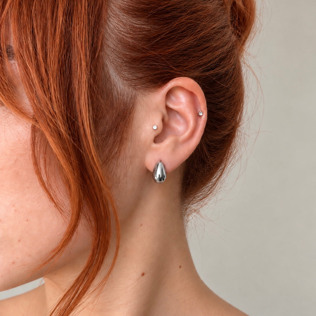 Nadare Co. Remi earrings featuring a chunky, sculptural teardrop design in polished silver-tone stainless steel.
