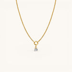 Nadare Co. gold chain necklace featuring a delicate round birthstone charm with a clear solitaire gemstone.