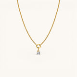 Nadare Co. gold chain necklace featuring a delicate round birthstone charm with a clear solitaire gemstone.