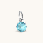 Nadare Co. round birthstone charm featuring a sparkling light blue cubic zirconia stone in a silver-tone setting.