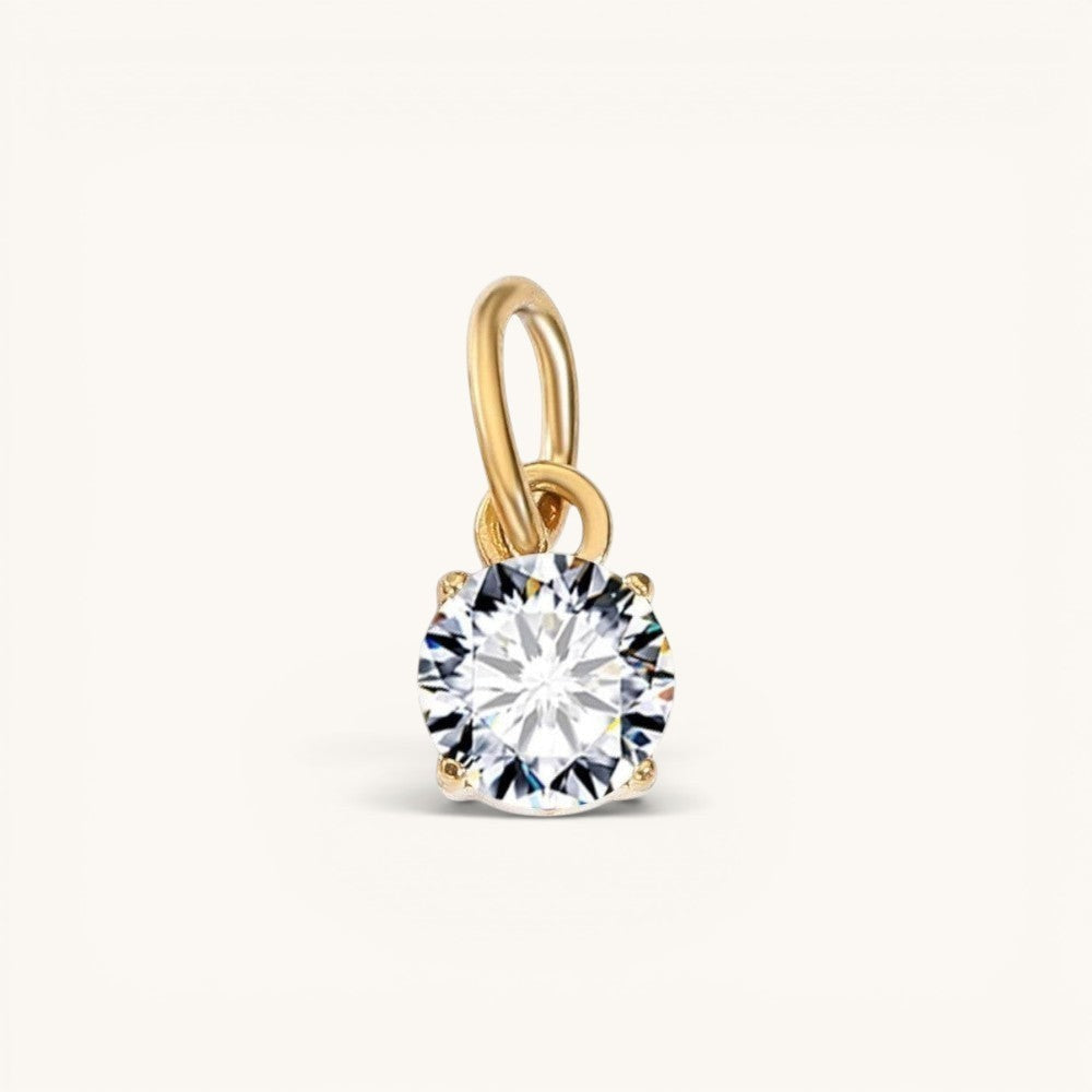 Nadare Co. round birthstone charm featuring a sparkling cubic zirconia stone in 14k gold-plated stainless steel.