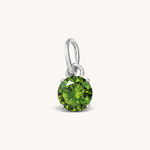 Nadare Co. round birthstone charm featuring a vibrant green cubic zirconia stone set in polished silver-tone metal.