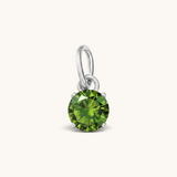 Nadare Co. round birthstone charm featuring a vibrant green cubic zirconia stone set in polished silver-tone metal.