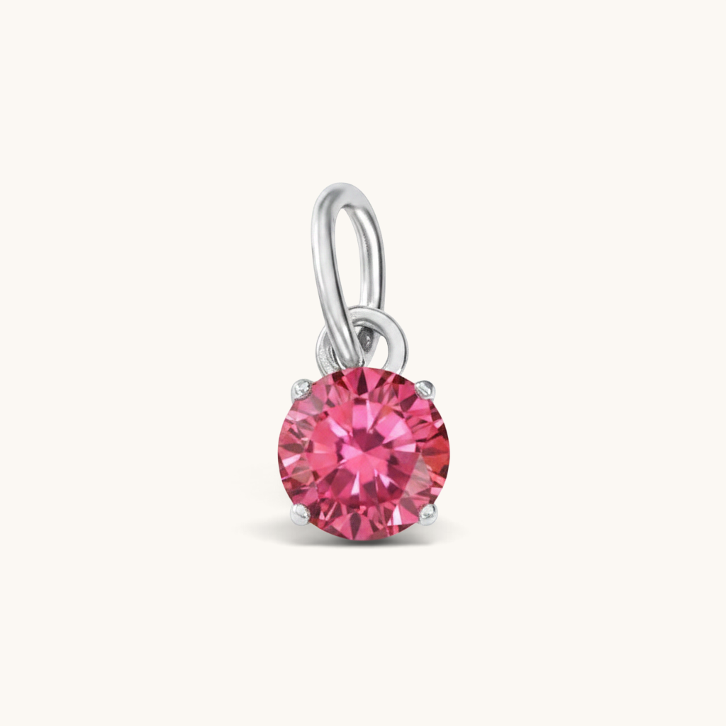 Nadare Co. round birthstone charm featuring a vibrant pink cubic zirconia stone set in polished silver-tone metal.