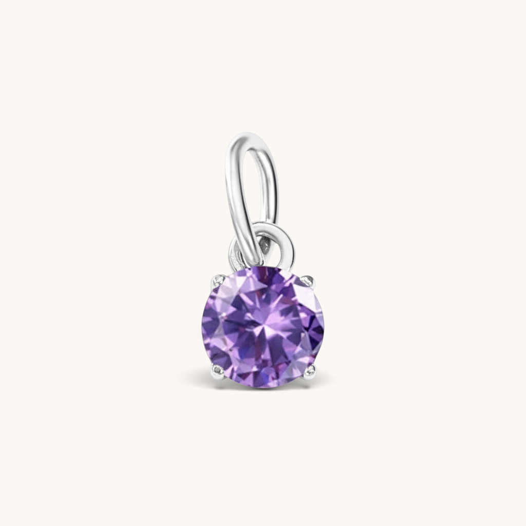 Nadare Co. round birthstone charm featuring a sparkling purple cubic zirconia stone set in silver-tone metal.
