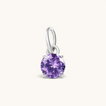 Nadare Co. round birthstone charm featuring a sparkling purple cubic zirconia stone set in silver-tone metal.