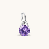 Nadare Co. round birthstone charm featuring a sparkling purple cubic zirconia stone set in silver-tone metal.