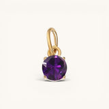 Nadare Co. round birthstone charm featuring a deep purple cubic zirconia set in 14k gold plated stainless steel.