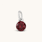 Nadare Co. round birthstone charm featuring a deep red cubic zirconia stone in a silver-toned setting