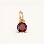 Nadare Co. round birthstone charm featuring a deep red cubic zirconia in 14k gold-plated stainless steel