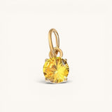Nadare Co. round birthstone charm featuring a yellow cubic zirconia stone in 14k gold plated stainless steel