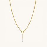 Nadare Co. short pearl drop charm on a gold chain, featuring a genuine freshwater pearl and 14k gold-plated steel.