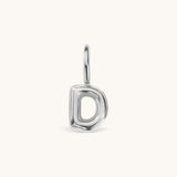 Nadare Co. silver-toned bubble initial charm in the shape of the letter D with a rounded, puffed design.