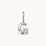 Nadare Co. silver-toned bubble initial charm in the shape of the letter G with a playful, puffed design.