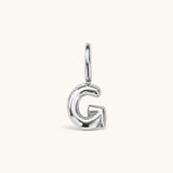 Nadare Co. silver-toned bubble initial charm in the shape of the letter G with a playful, puffed design.